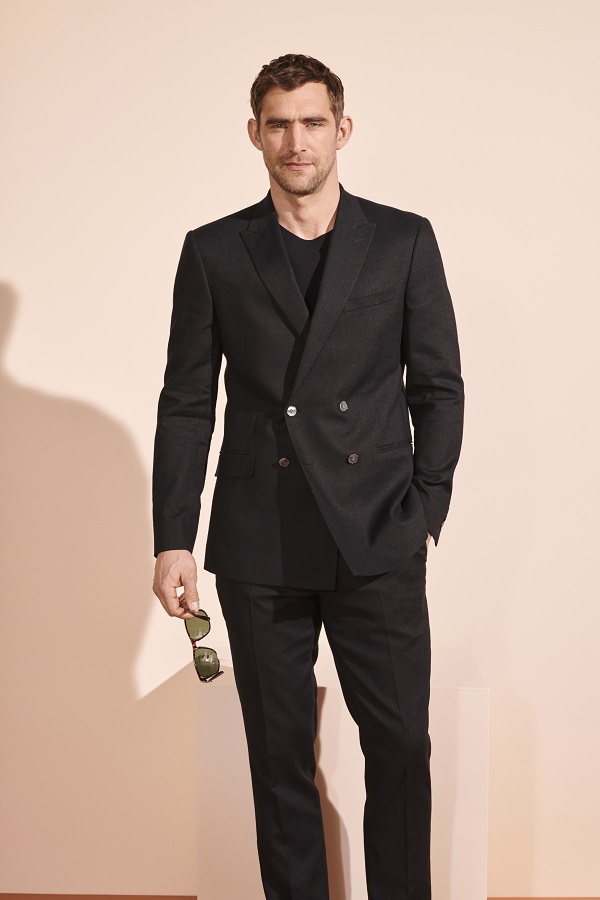 A man wearing a black suit from m&s