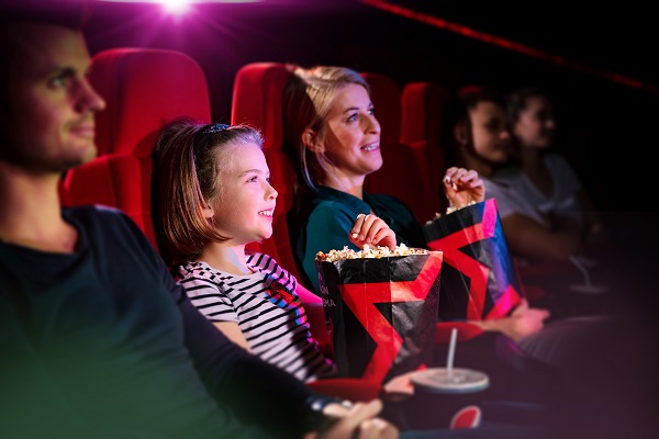 A family sitting in a cinema