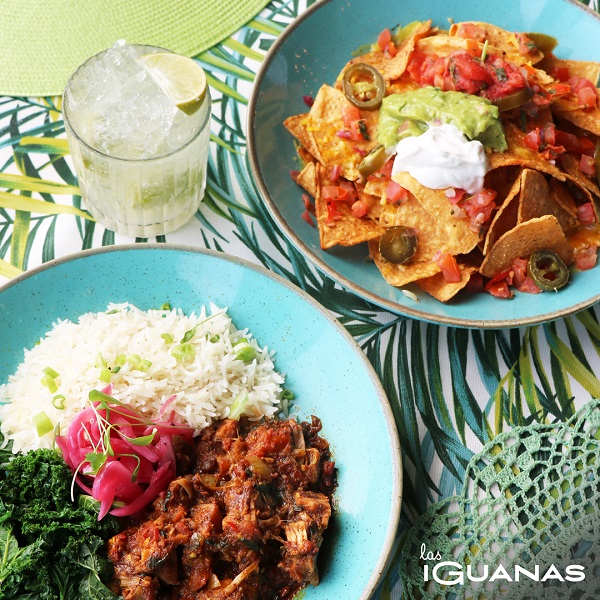 A plate with veggie chilli and nachos on.