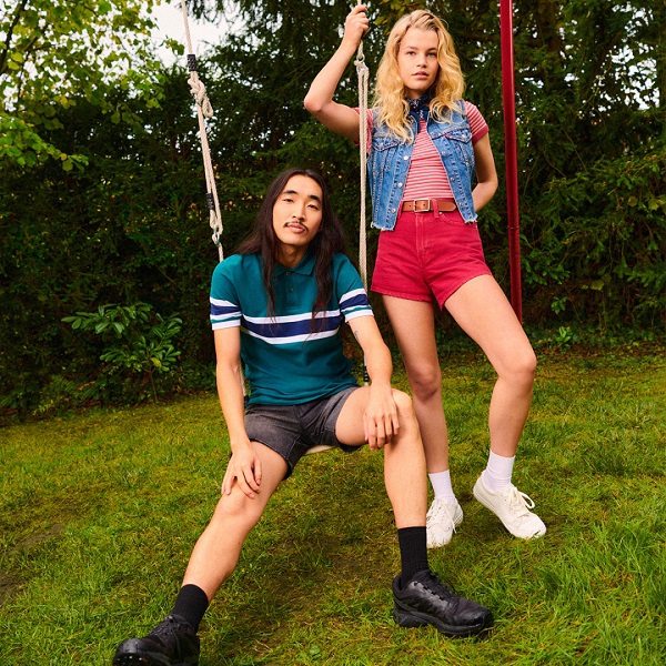 Two Levis models posing on swings