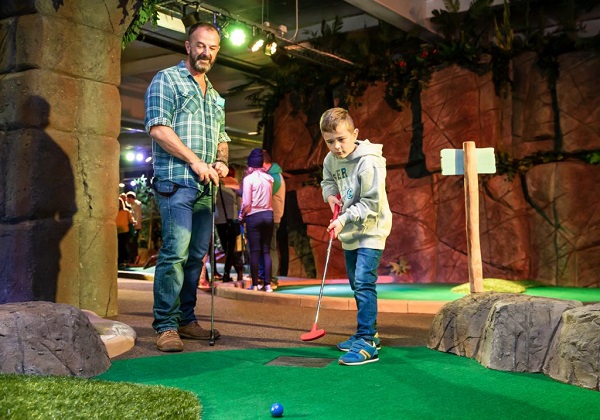 Family playing minigolf